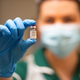 A nurse holds a vial of the Pfizer/BioNTech Covid-19 vaccine